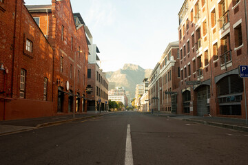 Red brick warehouse architectural buildings with empty road with mountain in background