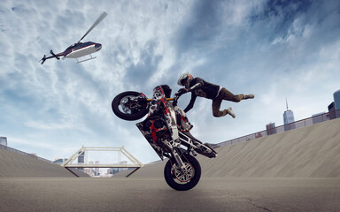 Moto rider making a stunt on his motorbike. Biker doing a difficult and dangerous stunt.