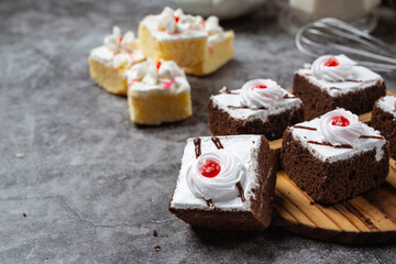 Vanilla cakes and chocolate cut into beautiful decorative pieces.