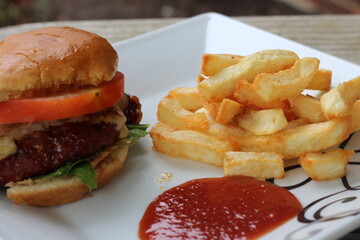 Homemade hamburger and fries with ketchup