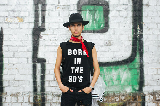 Fashionable young man with hat wearing t-shirt with saying 'Born in the 90s'