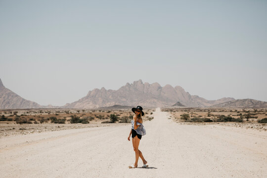 Namibia, happy woman on the road to Spitzkoppe