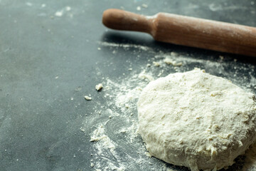 Dough pizza background. Cooking pizza dough or bread on the kitchen table. Food background