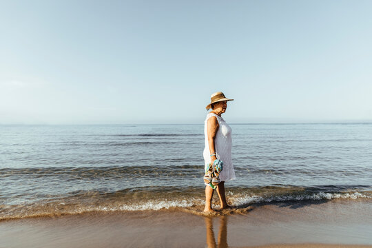 Senior woman wading in the sea, El Roc de Sant Gaieta, Spain
