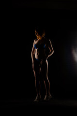 Obraz na płótnie Canvas Beautiful female body in black linen on a dark background