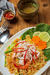 Delicious seafood fried rice with shrimp, eggs and spring onions with soup.