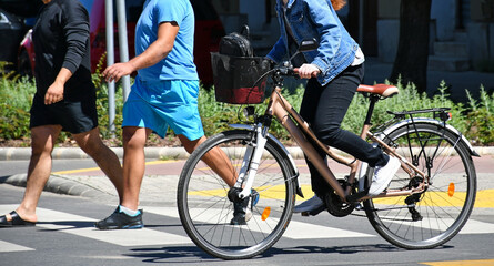 Woman with bicycle on the city street
