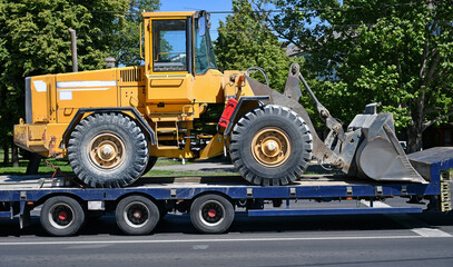 Excavator transported on a trailer