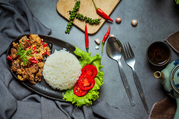 Stir fried pork, salt and chillies, decorated with Thai food ingredients.