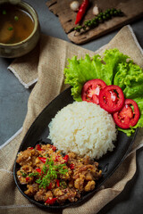 Stir fried pork, salt and chillies, decorated with Thai food ingredients.