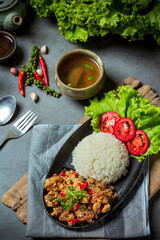 Stir fried pork, salt and chillies, decorated with Thai food ingredients.