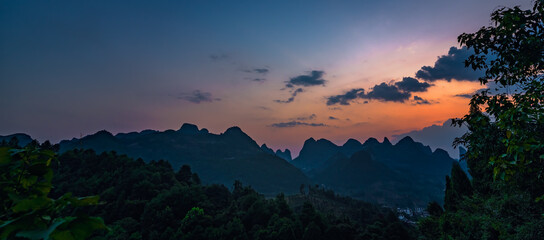 Panorama of Yangshuo landscape from Xianggong Hill viewpoint at dusk