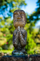 stone statue of a man praying