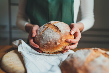 Closeup of woman holding homemade sourdough bread, Cooking at home, Artisan Product, Healthy Food Preparation Concept