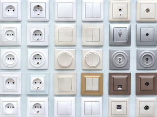 Samples of plastic switches and sockets of various shapes and colors.