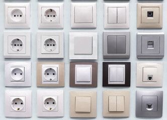 Samples of plastic switches and sockets of various shapes and colors.