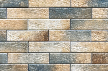 Brick wall of beige and brown bricks. Background and texture of brickwork.