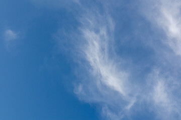 Clear blue sky with white clouds.