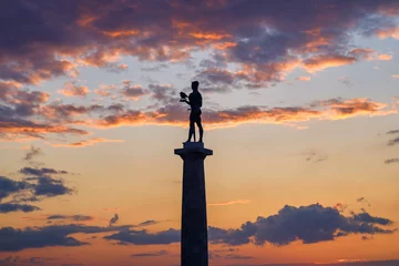 Fotobehang Silhouette of Victor monument, symbol of Belgrade, with beautiful sunset sky in the background, at Belgrade fortress Kalemegdan in Belgrade, Serbia © Mirko