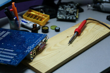 soldering iron is in the electrical workshop near with computer circuit