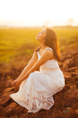 Portrait of beautiful woman smiling at park during sunset. Outdoor portrait of a smiling asian woman.