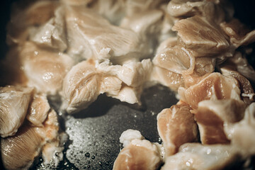 Pieces of meat are fried in oil. Large clan. Selective focus
