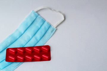 medical mask, pills on a white background