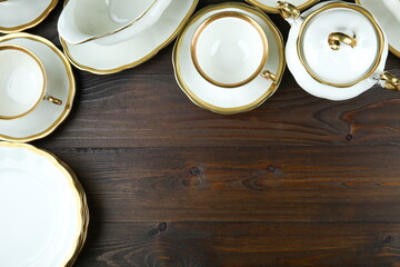 luxury empty porcelain tableware on dark wooden background top view with copy space