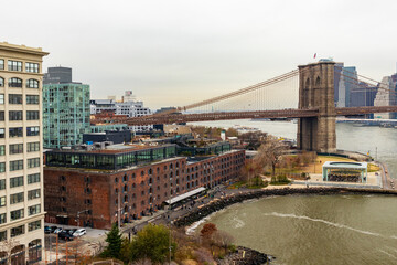 View of DUMBO, including the Brooklyn Bridge, Empire Fulton Ferry Park, Jane's Carousel, and Empire Stores