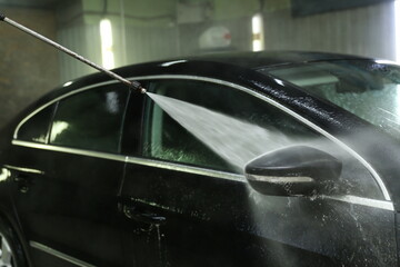 car washing by jet of water close-up. contactless car wash