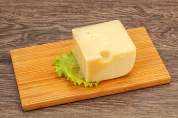 Emmental cheese over wooden board