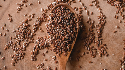 Flax seeds on a wooden spoon on the table top view. Super food