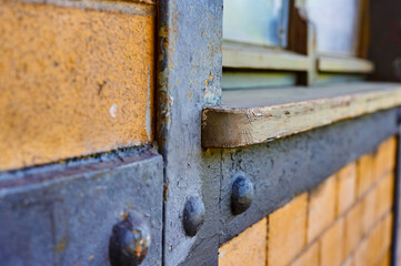 Details of a historic station building in Berlin, Germnany. You can see a weathered wooden window sill and the frame in a brick wall.
