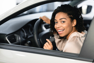 Lady Buyer Showing Auto Key Sitting In Automobile In Dealership