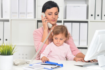 Businesswoman with her child working in office