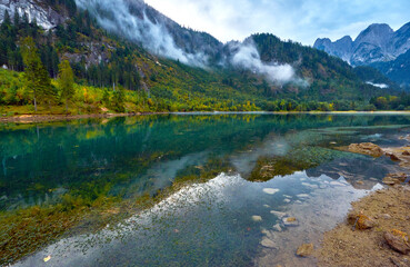 Fototapeta na wymiar Foggy day at alpine lake. Austria