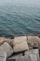 Barceloneta beach ocean and concrete groynes view vertical