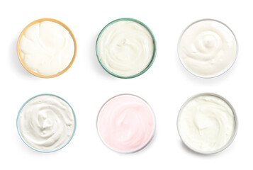 Set of delicious natural yogurts in bowls on white background, top view