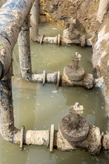 Used muddy water pipe valve in a trench