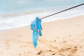 dirty face mask on the beach