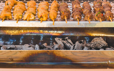 closeup of some meat skewers being grilled in a barbecue