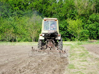 Plowed field by tractor in brown soil on open countryside nature