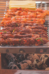 closeup of some meat skewers being grilled in a barbecue