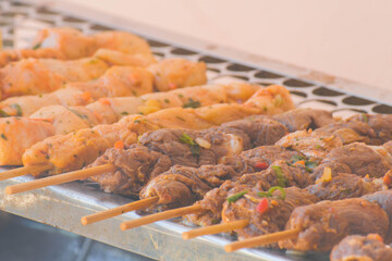 closeup of some meat skewers being grilled in a barbecue