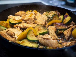 Frying zucchini and chicken in the pan