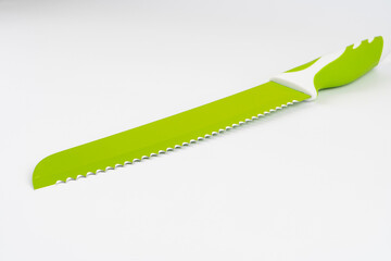 Lime green ceramic kitchen knives on a white background