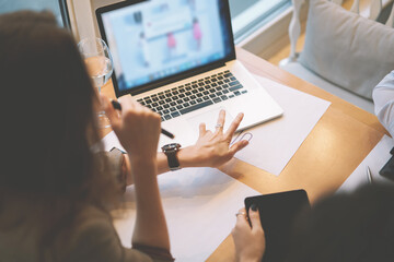 Modern three female colleagues brainstorming about work