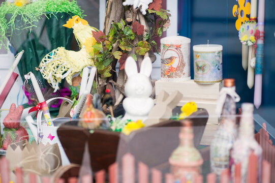 Shop window with souvenir Easter decorations, candles and painted eggs.