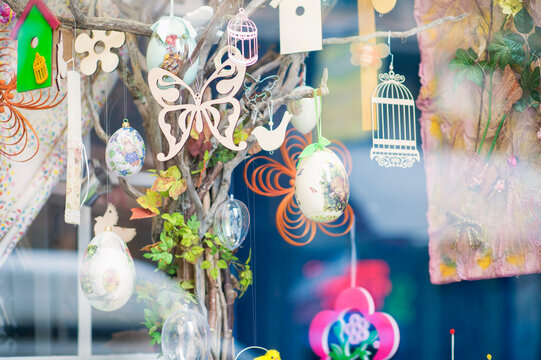 Shop window with souvenir Easter decorations, candles and painted eggs.