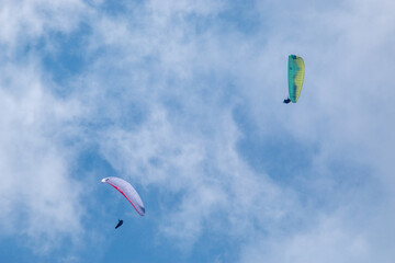 paragliding flying with parachutes in the clouds